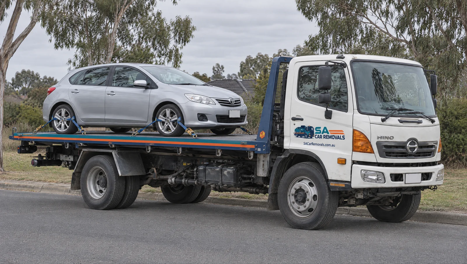 Illustration of a car secured on a flatbed truck with SA Car Removals branding.